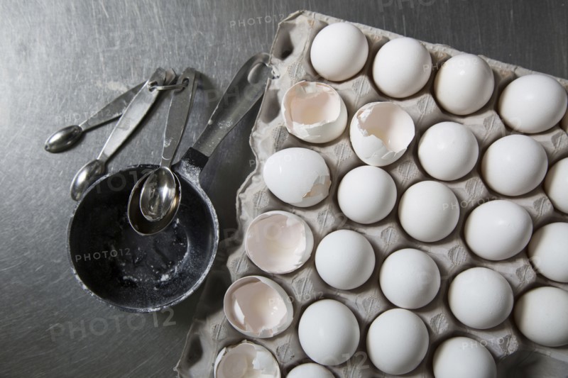 Carton of eggs with measuring spoons