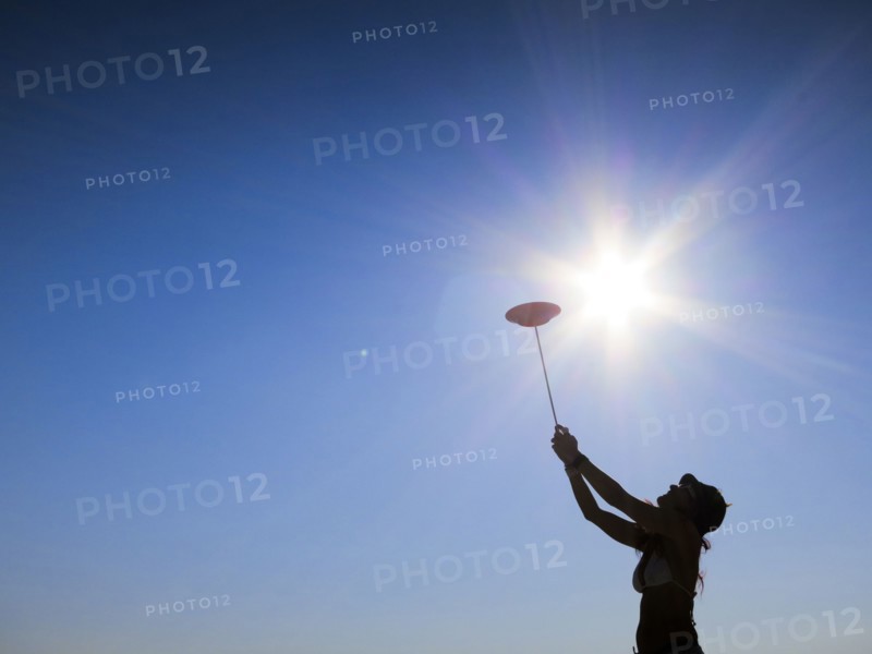 Silhouette of woman spinning plate