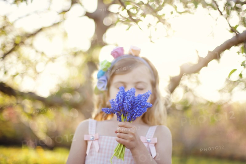 Caucasian girl smelling flowers outdoors
