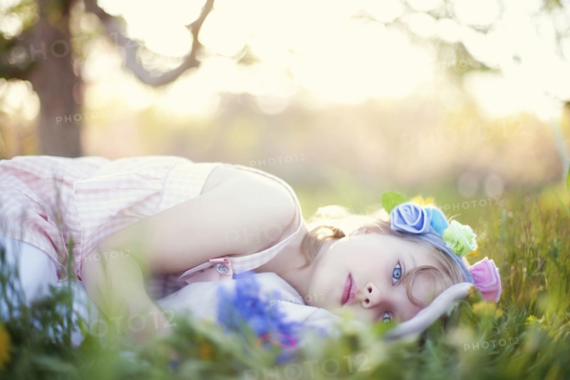Caucasian girl laying in grass