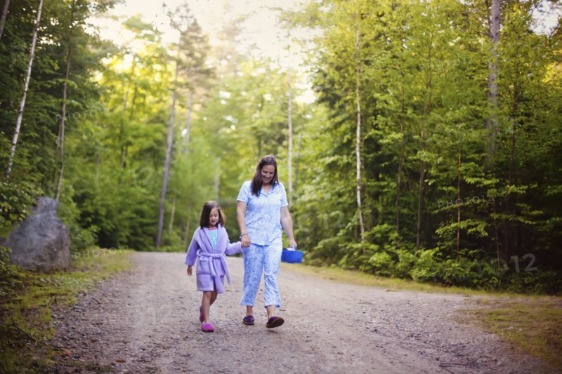 Caucasian mother and daughter walking on dirt road