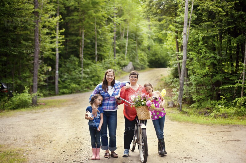 Three generations of Caucasian women standing on dirt road