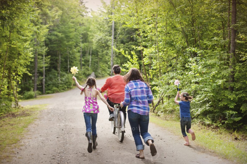 Three generations of Caucasian women walking on dirt road