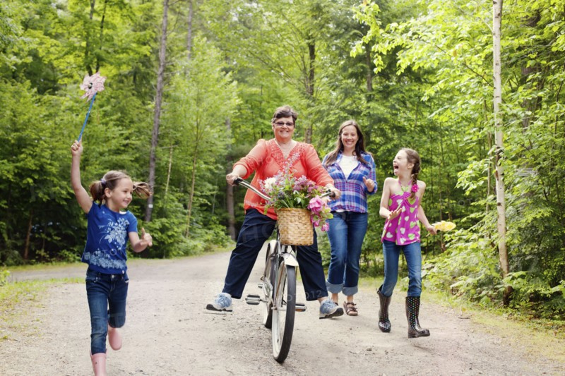 Three generations of Caucasian women walking on dirt road