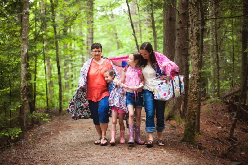 Three generations of Caucasian women walking in forest