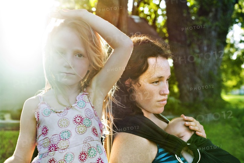 Serious mother and children outdoors