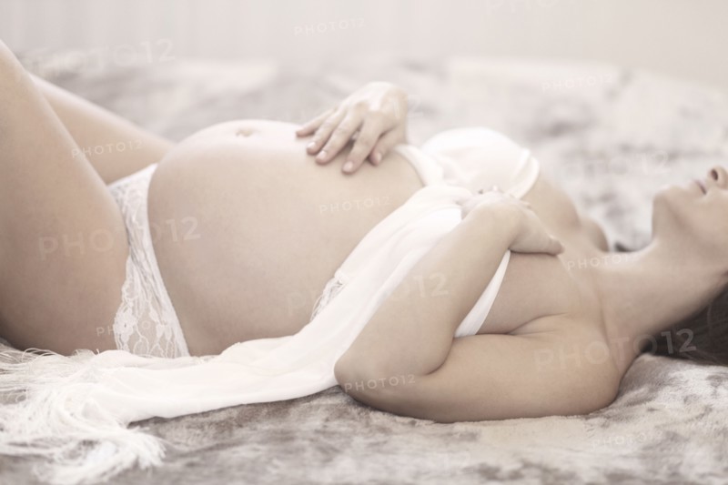 Pregnant Caucasian woman laying