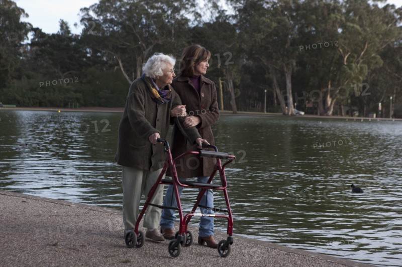 Woman walking with mother at pond