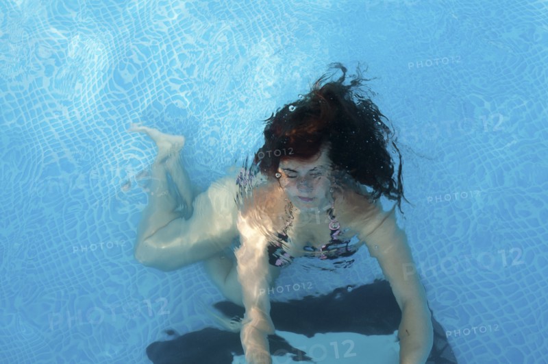 Caucasian woman swimming in pool