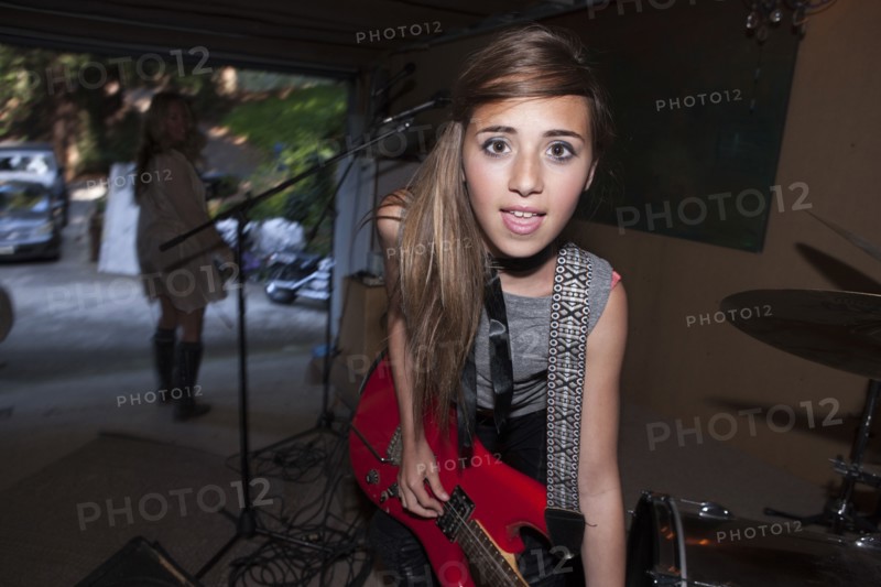 Girl playing guitar in rock band