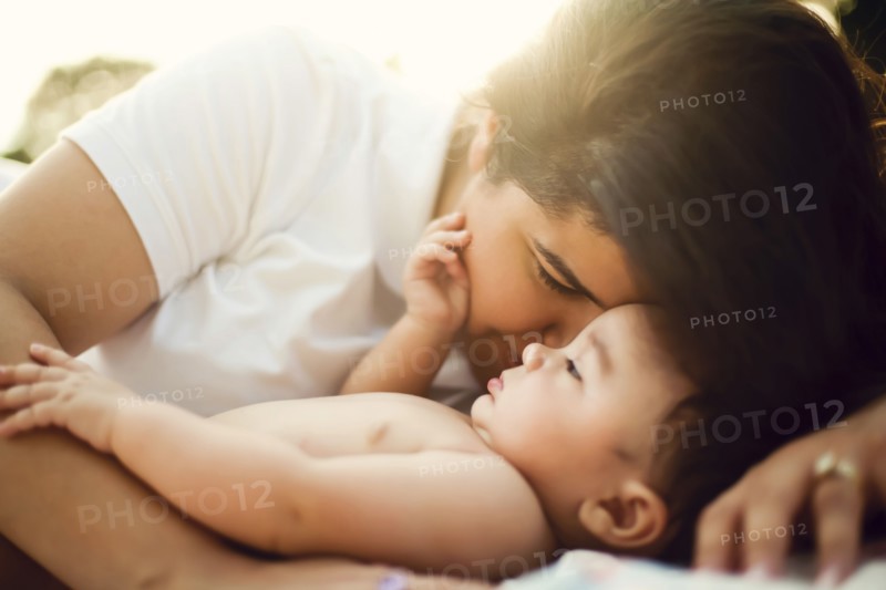Mixed race mother nuzzling baby