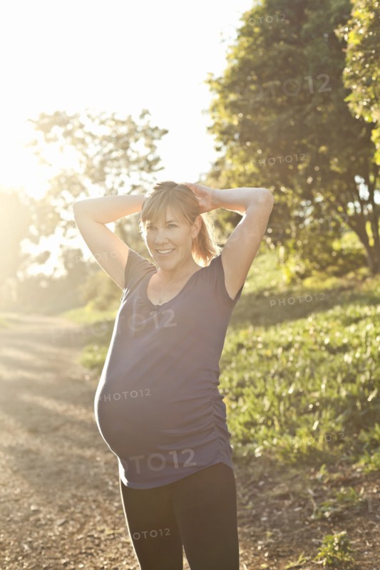 Pregnant Caucasian woman exercising outdoors