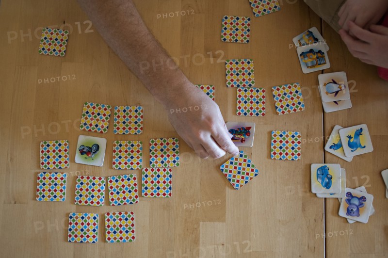 People playing tile game on wooden table