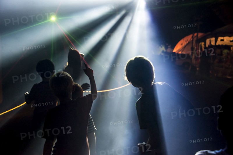 Silhouette of children under spotlights at night