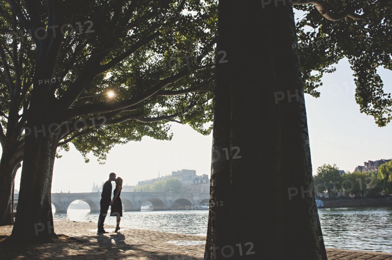 Caucasian couple kissing near bridge