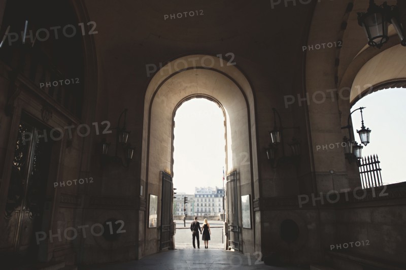 Caucasian couple standing in church archway