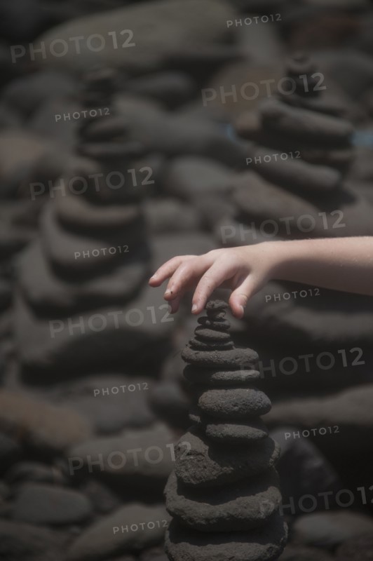 Close up of hand stacking rocks