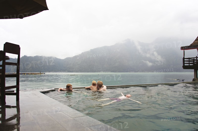 Caucasian children admiring scenic view from swimming pool