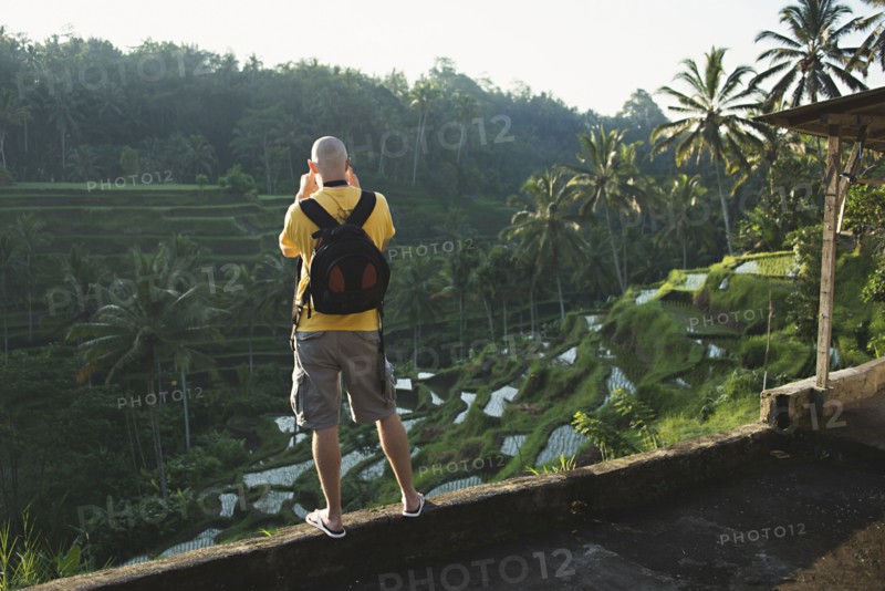 Caucasian tourist photographing rural rice terrace