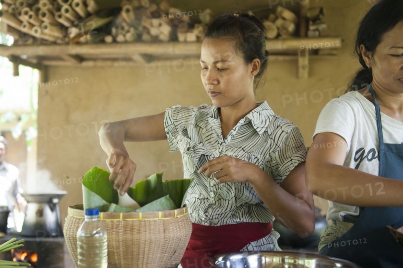 Asian chefs cooking in outdoor kitchen