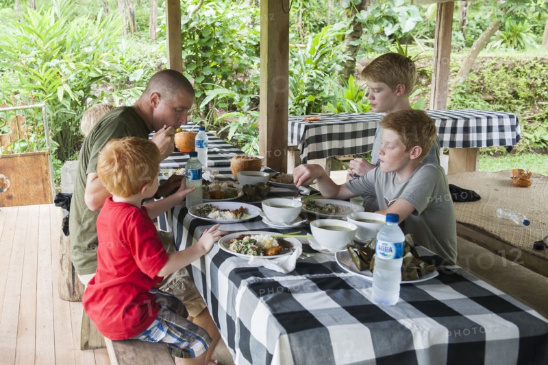 Caucasian family eating at picnic table outdoors