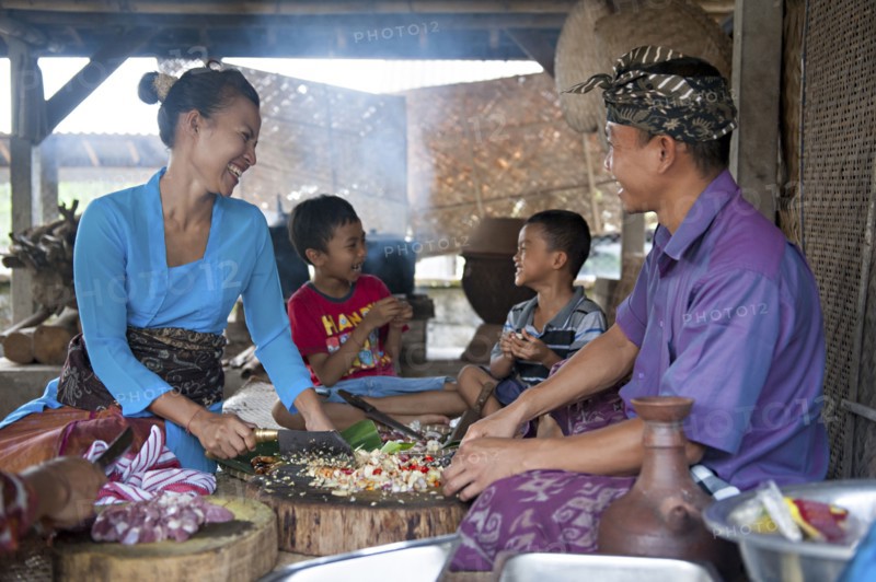 Asian family cooking together in outdoor kitchen