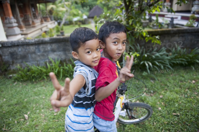 Asian boys playing in backyard