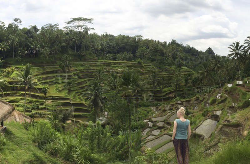 Caucasian tourist admiring rural rice terrace