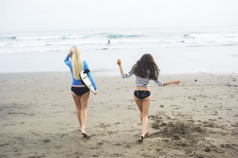 Caucasian women walking on beach