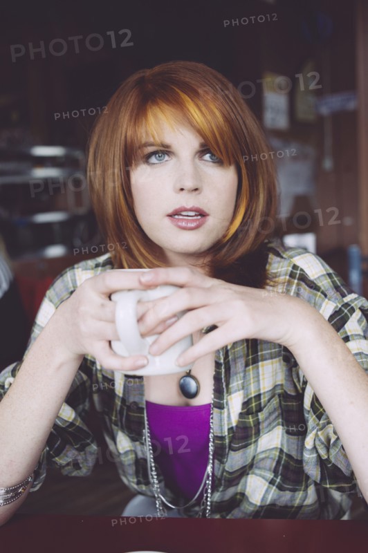 Caucasian woman drinking coffee in cafe