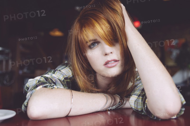 Caucasian woman leaning on table