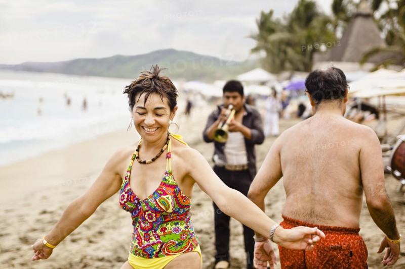 Hispanic people enjoying music on beach