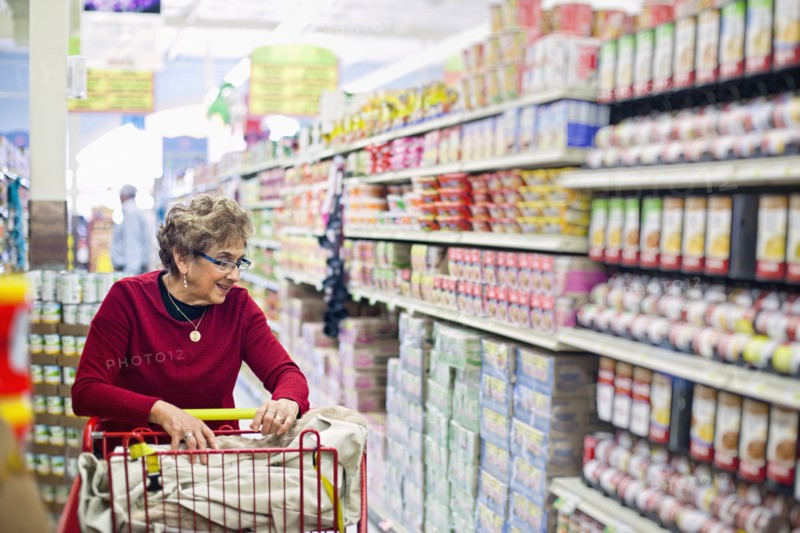 Senior Hispanic woman shopping in grocery store