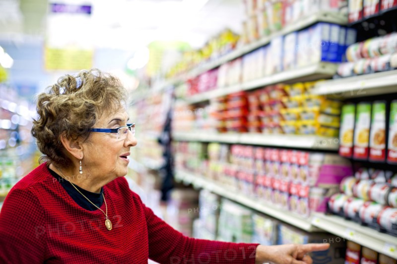 Senior Hispanic woman shopping in grocery store