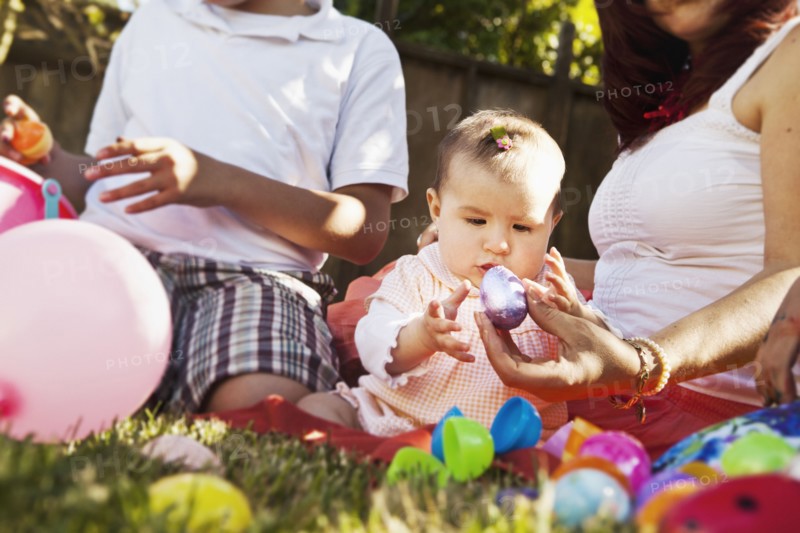 Hispanic baby playing with Easter eggs