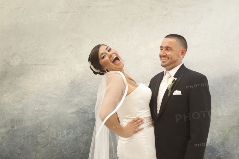 Hispanic bride and groom laughing