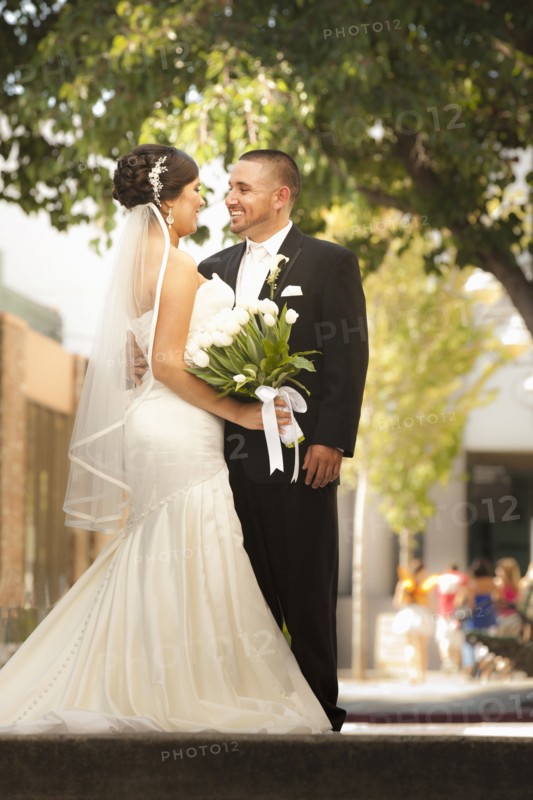 Smiling Hispanic bride and groom
