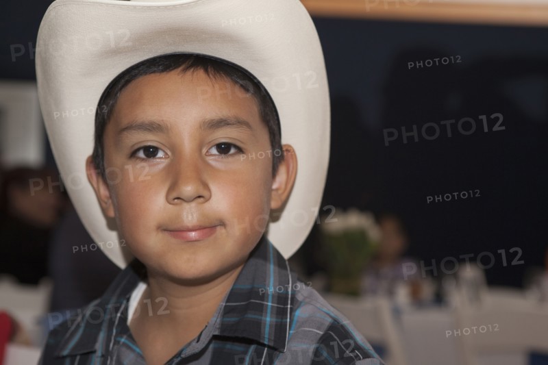 Hispanic boy wearing cowboy hat