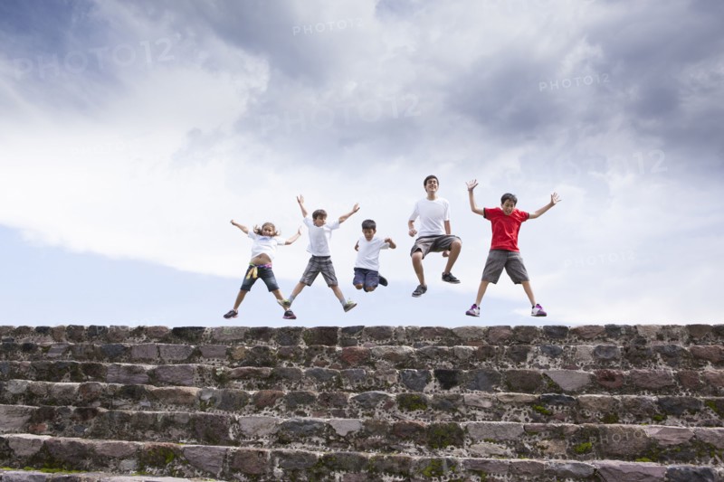 Children jumping on top of steps
