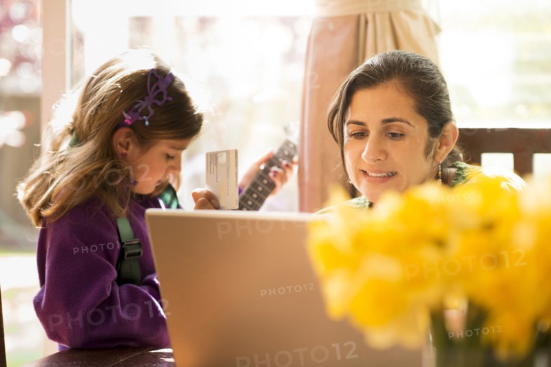 Mother shopping online with daughter
