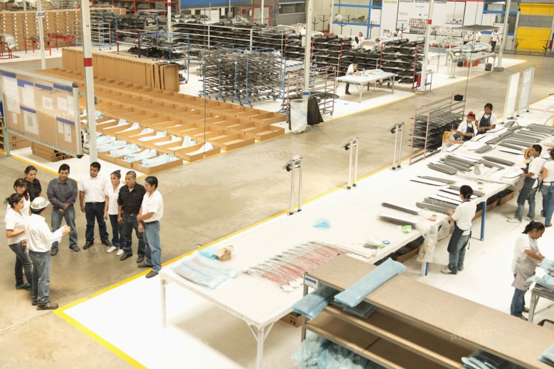 Workers talking in manufacturing plant