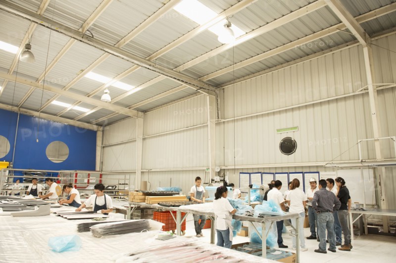 Workers talking in manufacturing plant