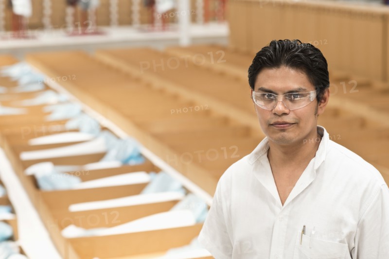 Worker standing in manufacturing plant