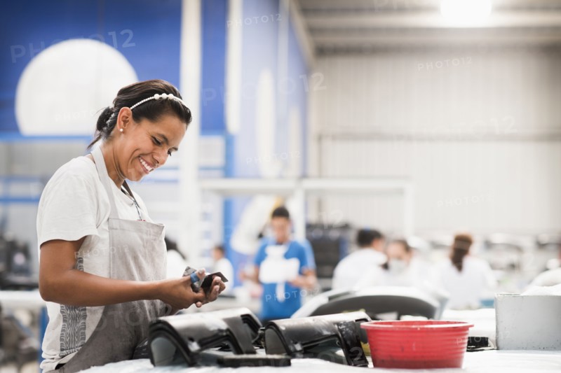 Worker smiling in manufacturing plant
