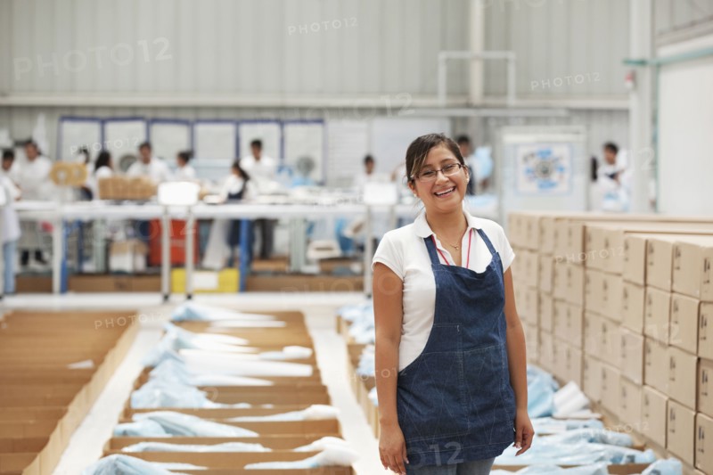 Worker smiling in manufacturing plant