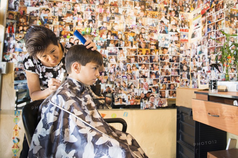Boy having hair cut in salon