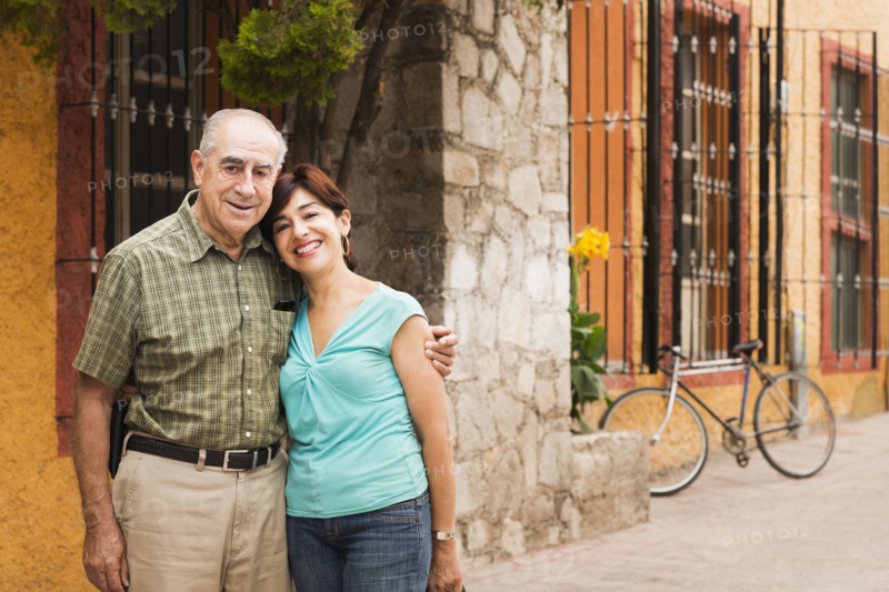 Hispanic couple smiling on city street