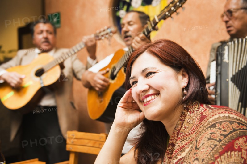 Hispanic woman in restaurant with traditional band