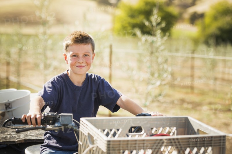 Caucasian boy driving four wheeler outdoors