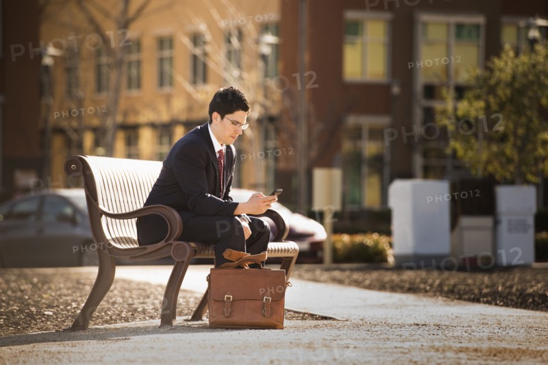 Hispanic businessman using cell phone